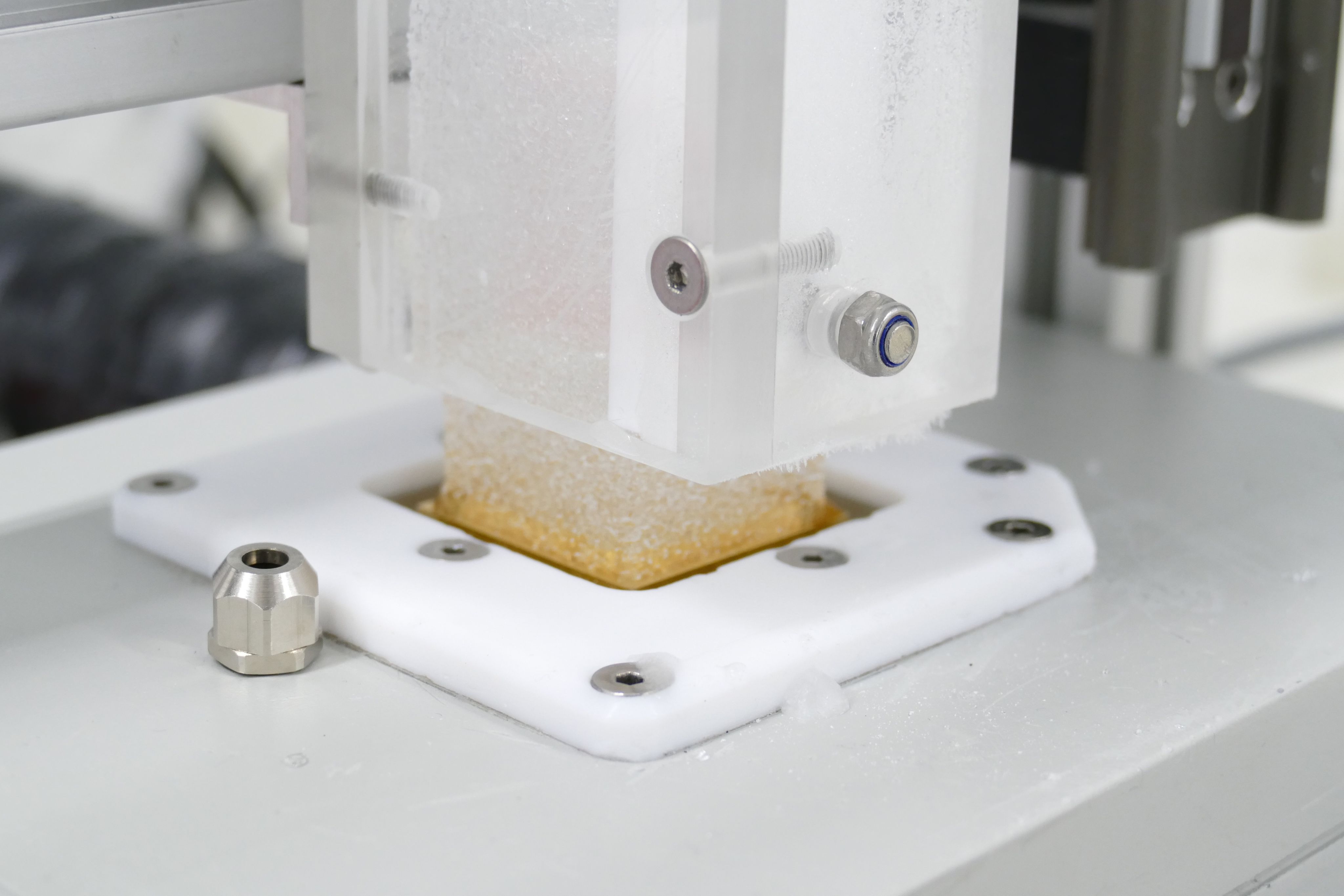 Melting a stick of ice on the melter for laboratory analysis. (Photo by Eric Wolff)