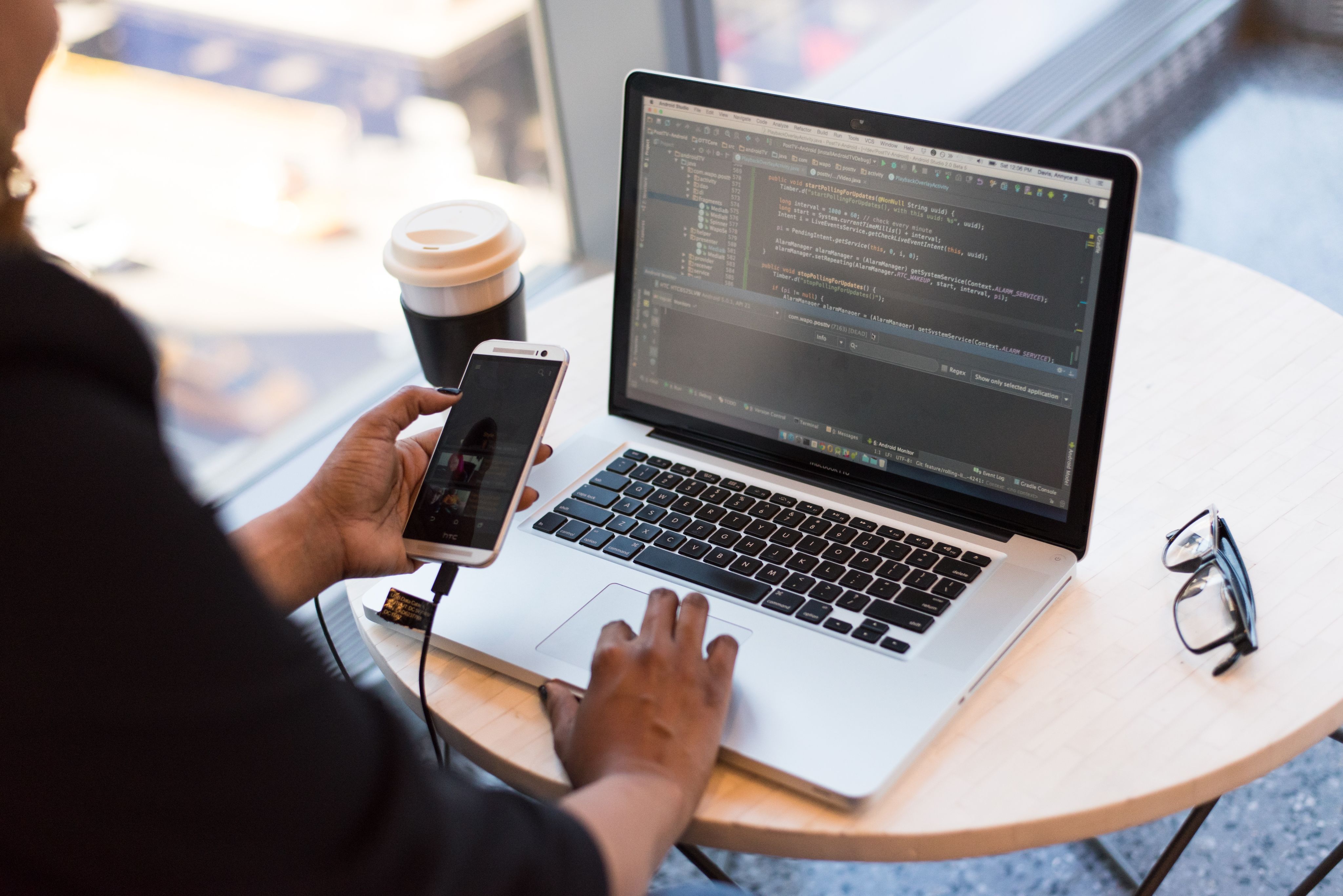 Woman on working on laptop and phone